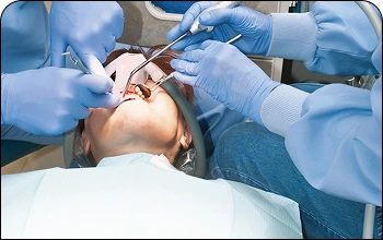 Specialized dental team performing oral surgery under sedation dentistry for patient comfort.