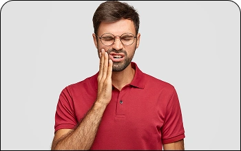 Man holding his cheek in discomfort due to a severe toothache.